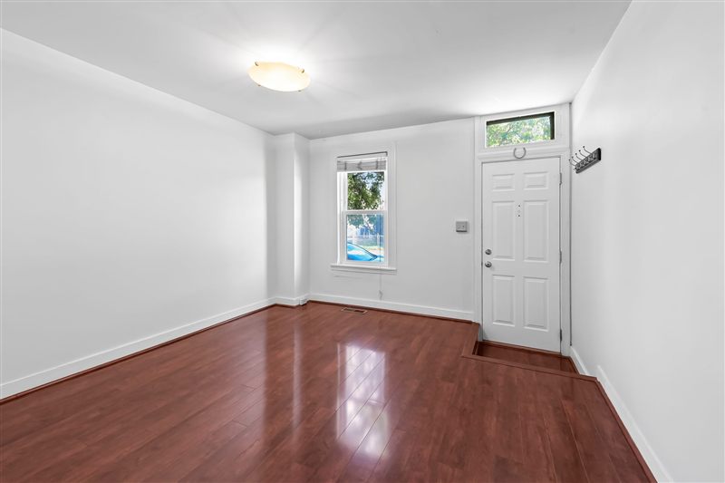 Living room with wood floors and the front door