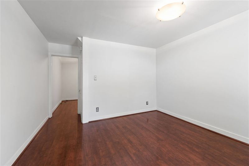 Dining room with wood floors and a hallway