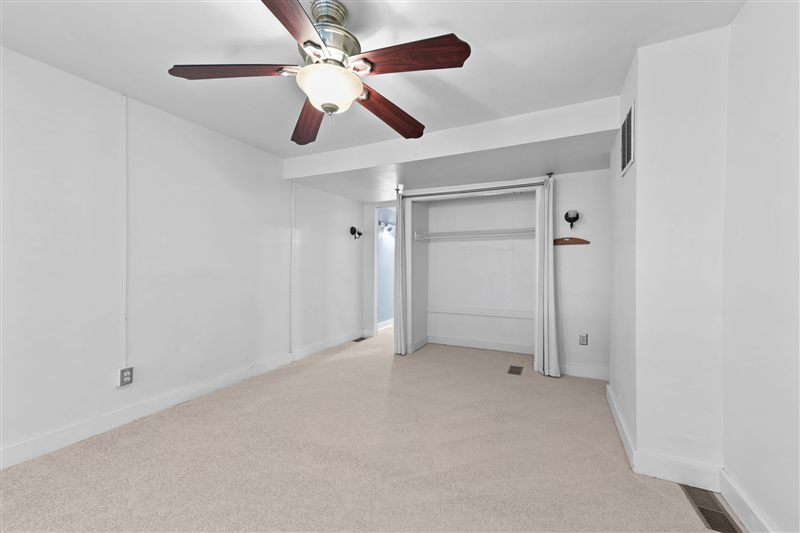 Second-floor room with a closet and a ceiling fan