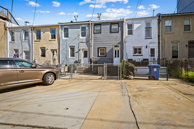 Rear of the home from the alley with the fenced yard