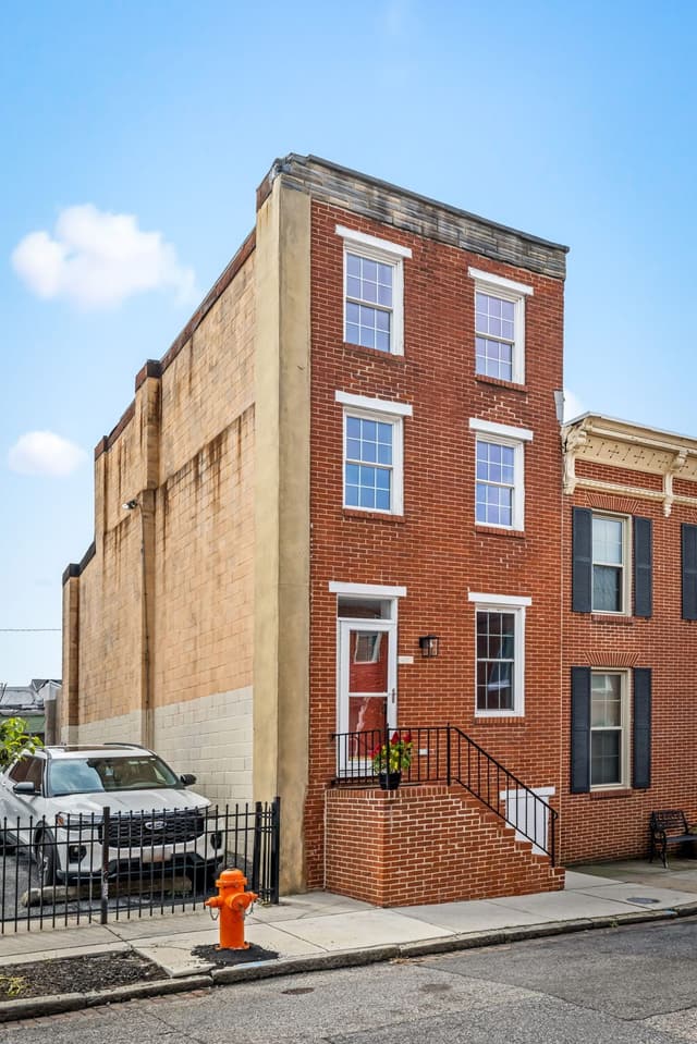 Tall view of the brick front and steps from the corner