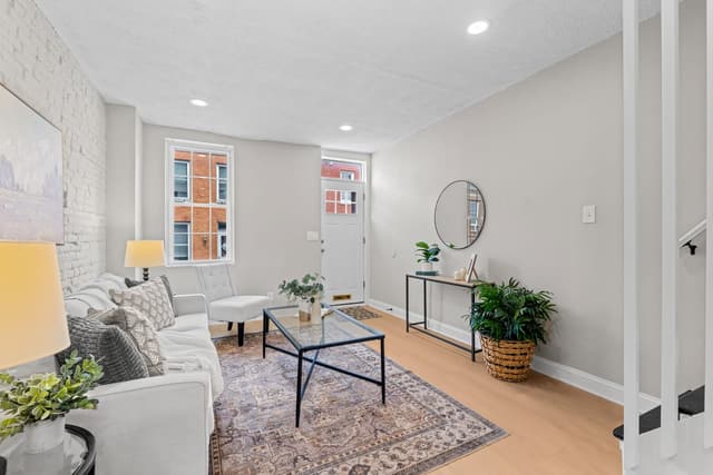 Living room with a painted brick wall and new flooring