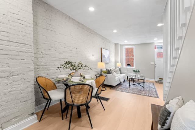 Dining area with a round table beside the staircase