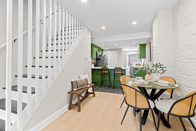 Dining area, staircase, and the kitchen at the back