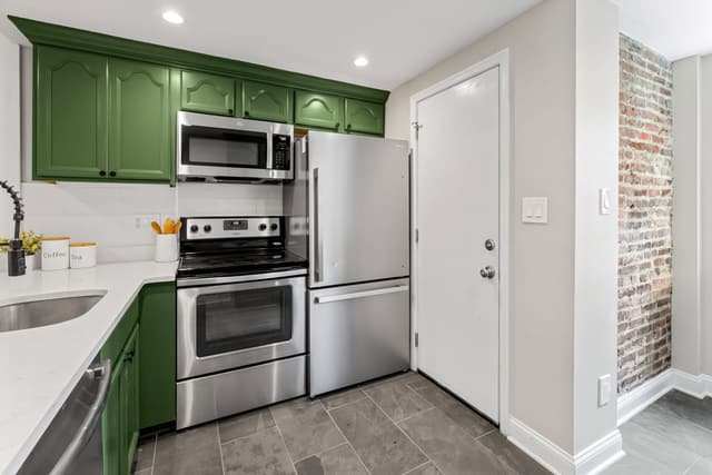 Kitchen with stainless range, microwave, and refrigerator