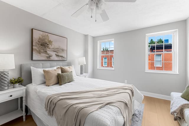 Bedroom with two windows and a ceiling fan