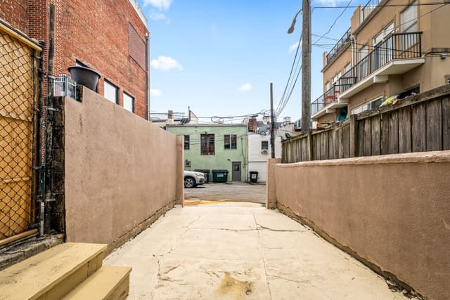 Concrete parking pad opening toward the alley