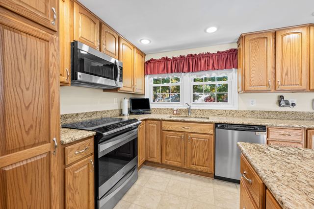 Kitchen with oak cabinets, granite counters and stainless appliances