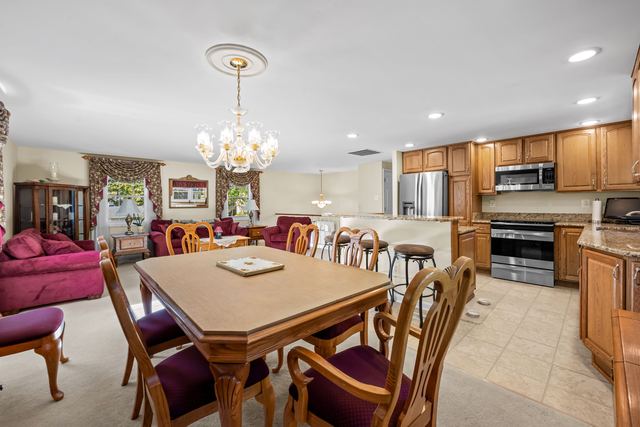Dining table with the kitchen and island behind it