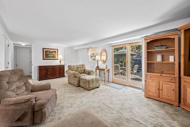 Lower level sitting area with sliding glass doors to the patio