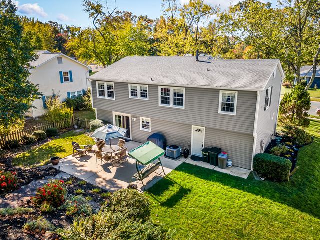 Aerial view of the back of the house, the patio and the yard